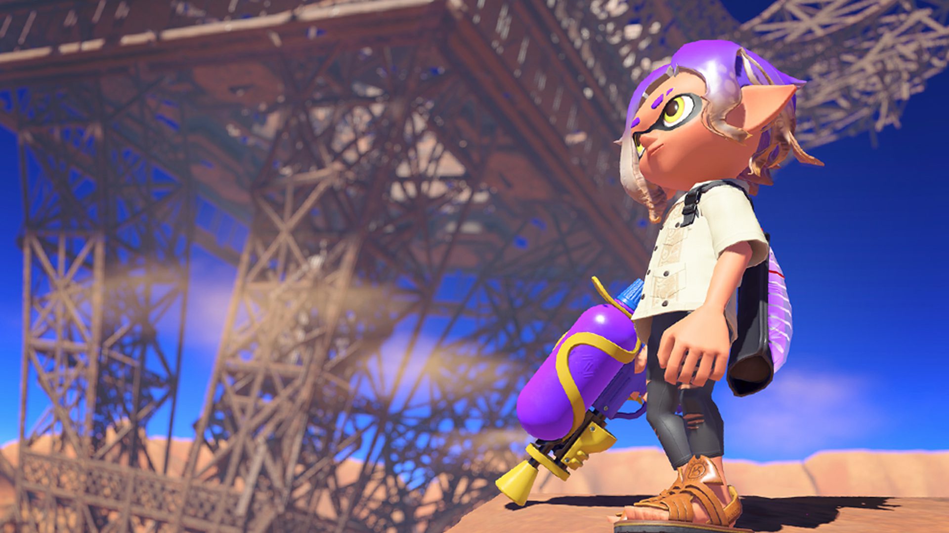 An inkling in Splatoon 3 standing in front of an upside down, ruined Eiffel Tower