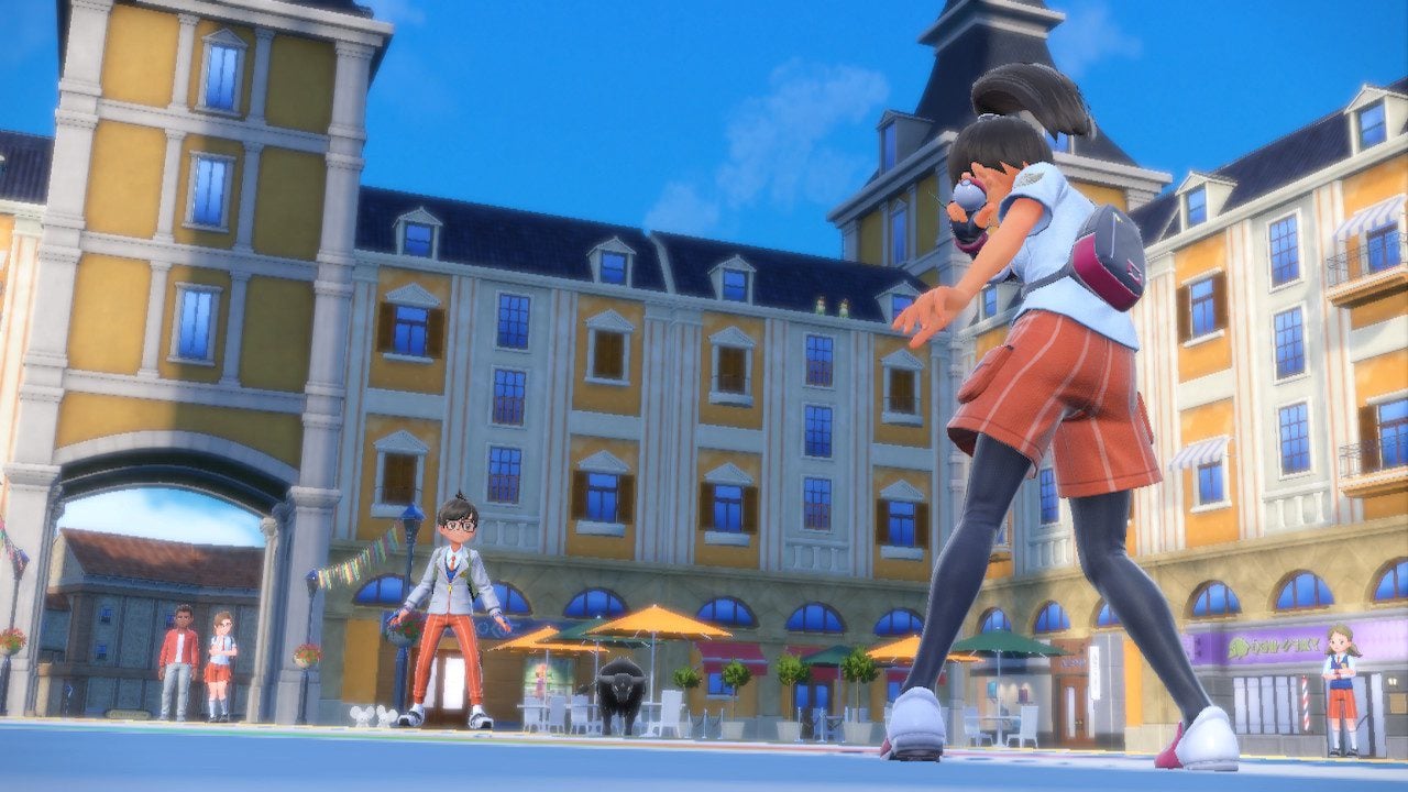 The player faces off against Nemona in a busy city plaza.