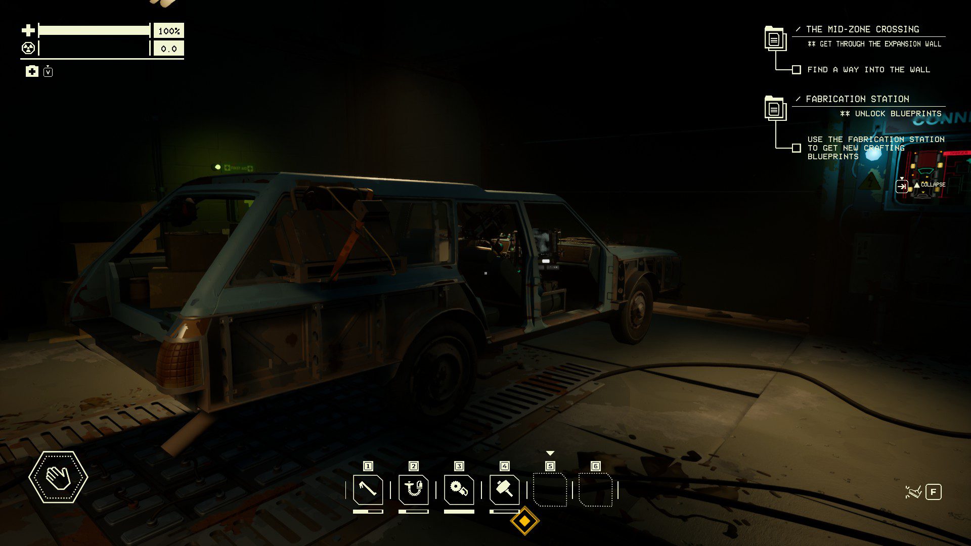The car in the garage with no panels or doors remaining