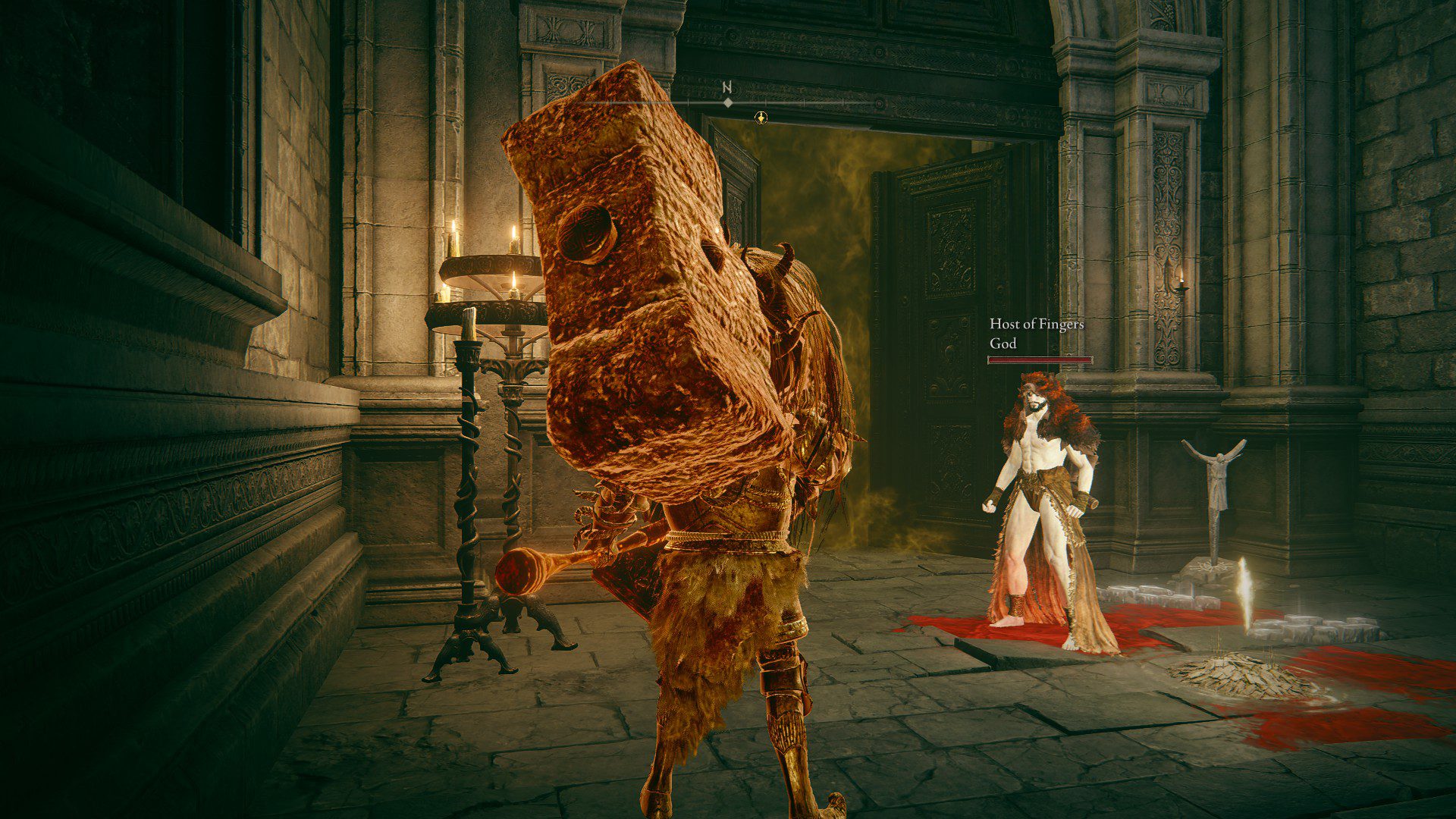 A character of another player, dressed in a red bear suit, called "God" stands in front of my player character in front of a boss gate