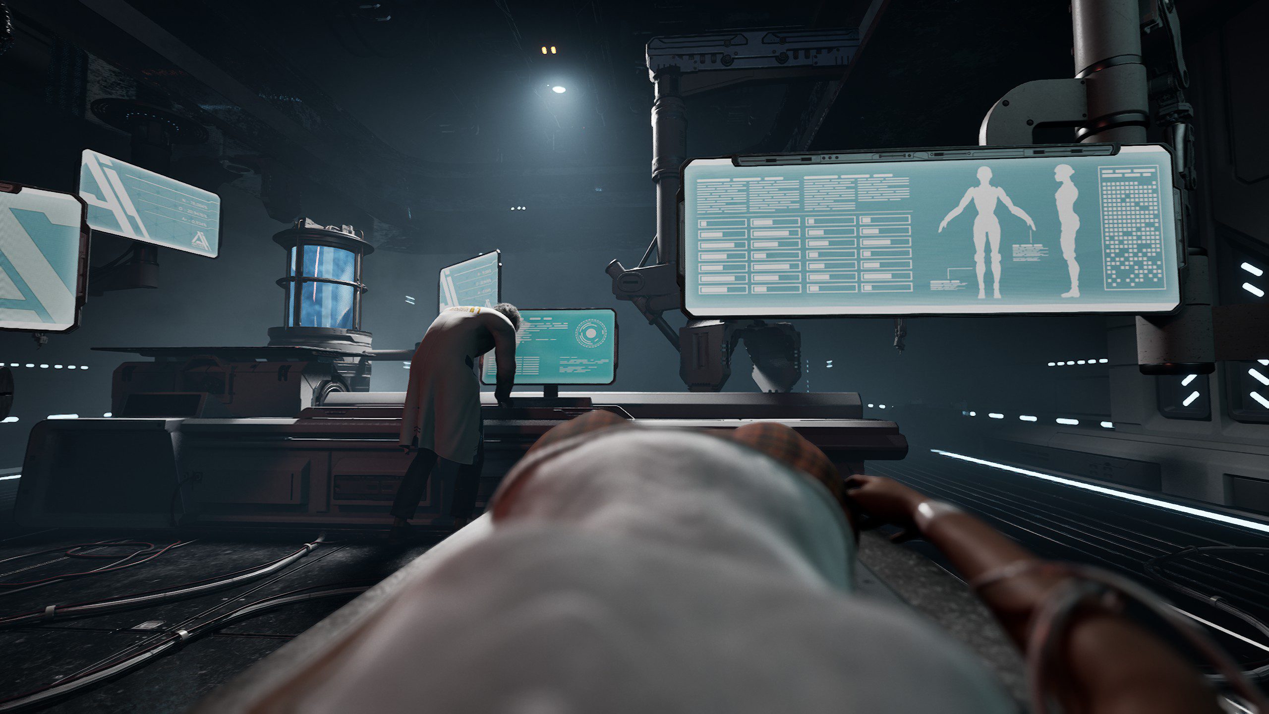 Steel Seed screenshot showing the protagonist lying down as a man in lab coat is working on computers.
