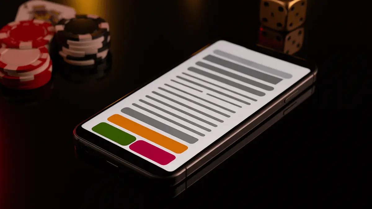 Smartphone showing mobile casino app interface with casino chips and cards on black table