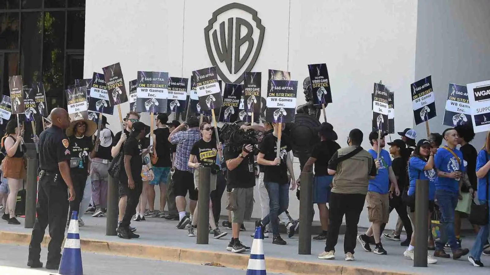 Protesters holding signs for a video game strike outside WB Games.