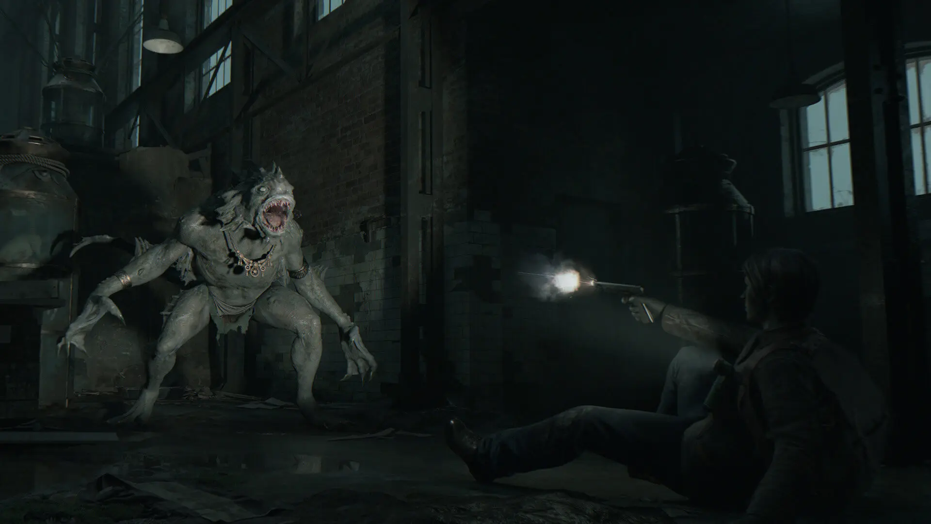 A man firing a handgun at a pale, monstrous creature in a dark industrial warehouse.