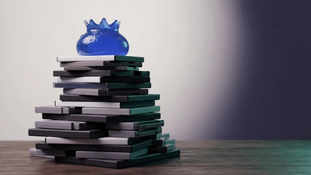 Blue fantasy RPG slime atop generations of game cases, symbolizing Dragon Quest reaching 100 million sales.