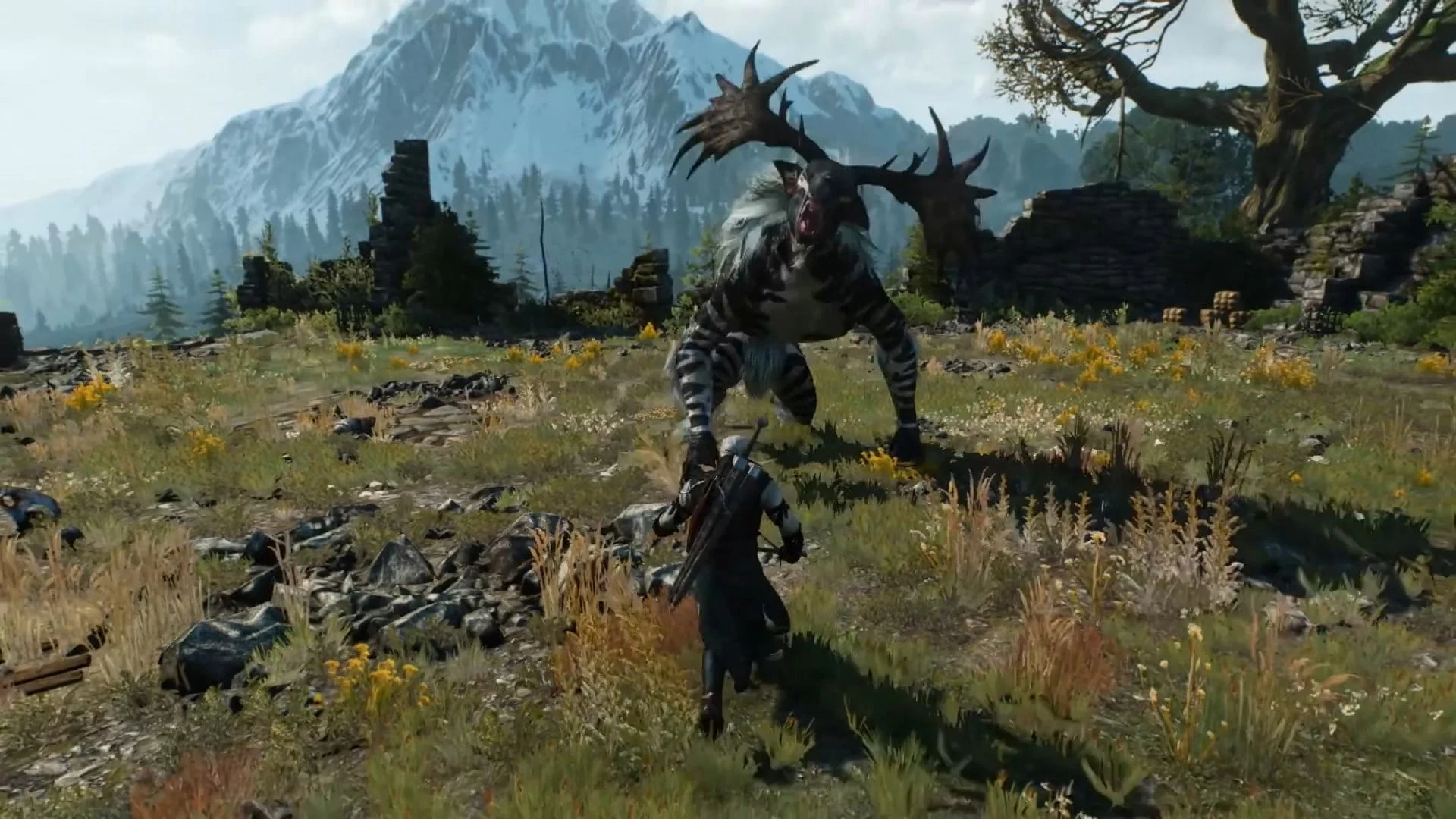 Geralt of Rivia fighting a large, antlered monster in a mountainous landscape from The Witcher 3: Wild Hunt